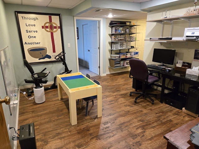 home office featuring a drop ceiling, baseboards, visible vents, and wood finished floors