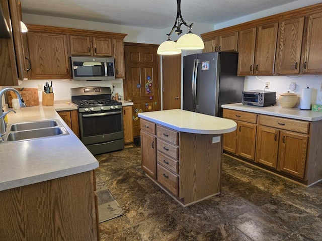 kitchen featuring a kitchen island, a toaster, light countertops, appliances with stainless steel finishes, and a sink