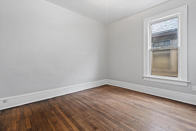 empty room featuring baseboards and hardwood / wood-style floors