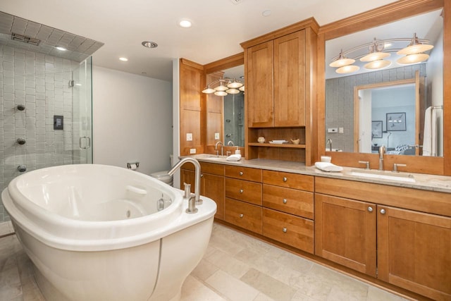 full bathroom with a freestanding tub, a stall shower, a sink, recessed lighting, and double vanity