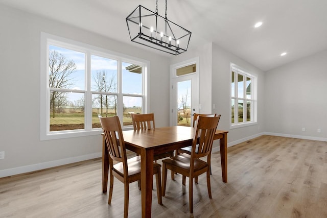 dining space featuring recessed lighting, baseboards, a notable chandelier, and light wood-style flooring