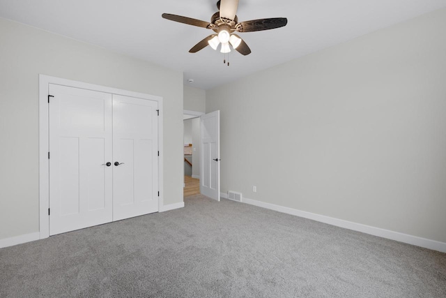 unfurnished bedroom featuring a closet, baseboards, and carpet floors