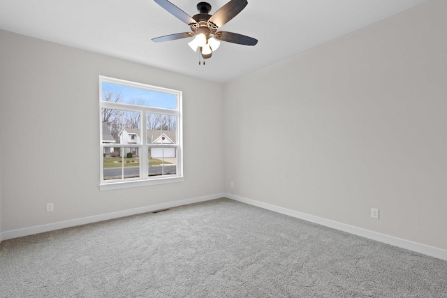 unfurnished room featuring visible vents, carpet, and baseboards