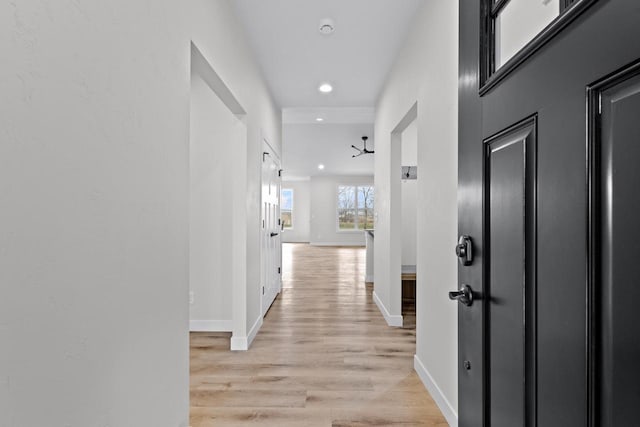 corridor with recessed lighting, light wood-style floors, and baseboards