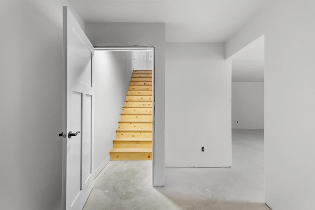 stairs with concrete flooring