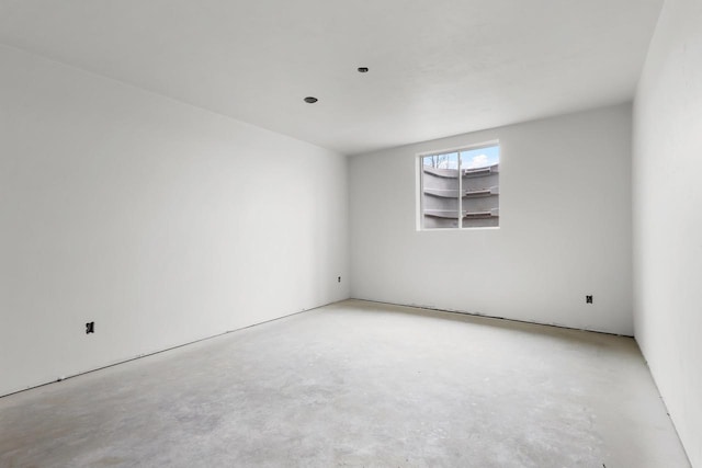 unfurnished room with unfinished concrete floors