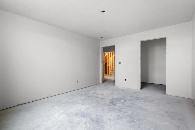 unfurnished bedroom with concrete flooring