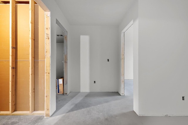 hallway with concrete flooring