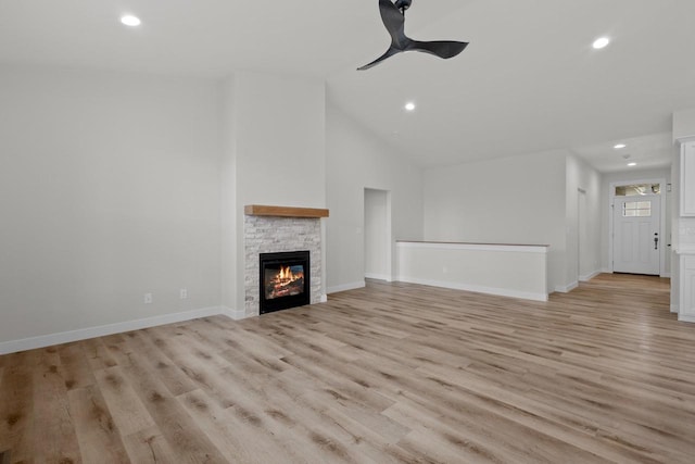 unfurnished living room with recessed lighting, a fireplace, baseboards, and light wood-style floors