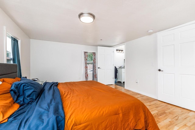 bedroom featuring multiple windows and wood finished floors