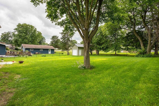 view of yard with an outbuilding and fence