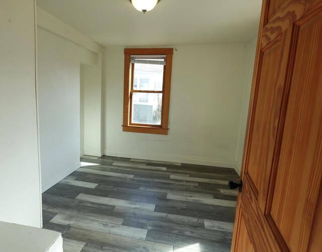 interior space with dark wood-style floors and baseboards