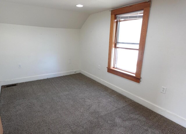 bonus room featuring visible vents, baseboards, carpet, and lofted ceiling