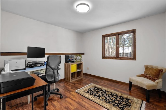 office space with dark wood finished floors and baseboards