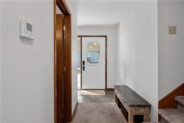 hallway featuring carpet floors and stairs