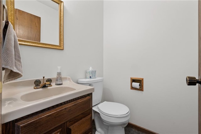 half bathroom with vanity and toilet