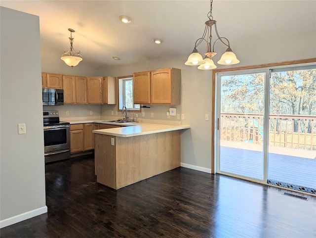 kitchen with visible vents, light brown cabinetry, a peninsula, stainless steel appliances, and a sink