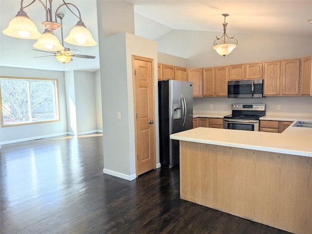 kitchen featuring dark wood-type flooring, light brown cabinetry, lofted ceiling, appliances with stainless steel finishes, and a peninsula