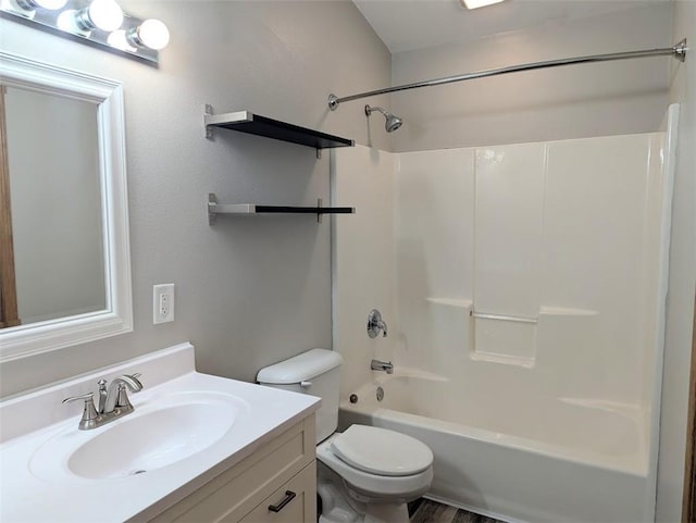 bathroom featuring bathing tub / shower combination, toilet, and vanity