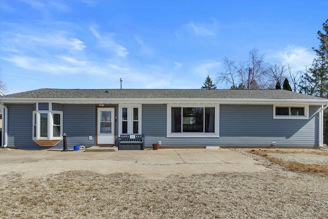 back of property featuring a shingled roof