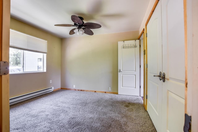 carpeted spare room with baseboard heating, baseboards, and ceiling fan