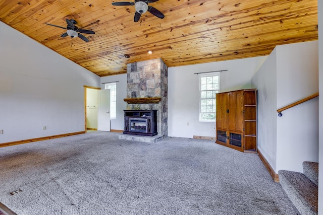 unfurnished living room featuring baseboards, wood ceiling, lofted ceiling, carpet flooring, and a stone fireplace