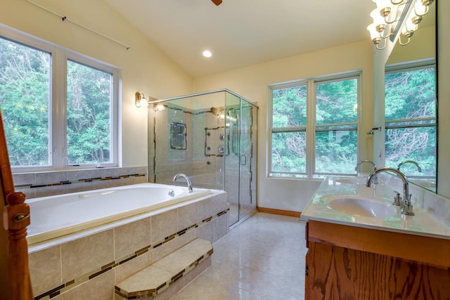 bathroom featuring a garden tub, a sink, tile patterned flooring, double vanity, and vaulted ceiling