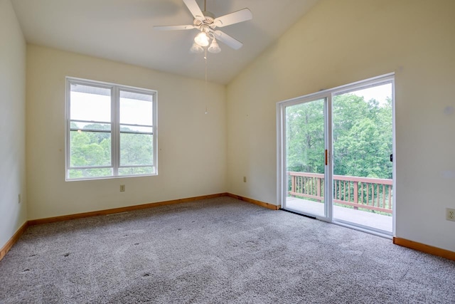 spare room with baseboards, ceiling fan, carpet flooring, and vaulted ceiling