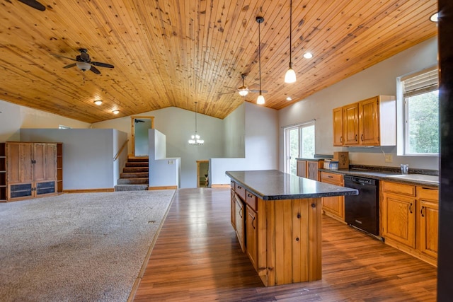 kitchen featuring dark countertops, open floor plan, dishwasher, and vaulted ceiling