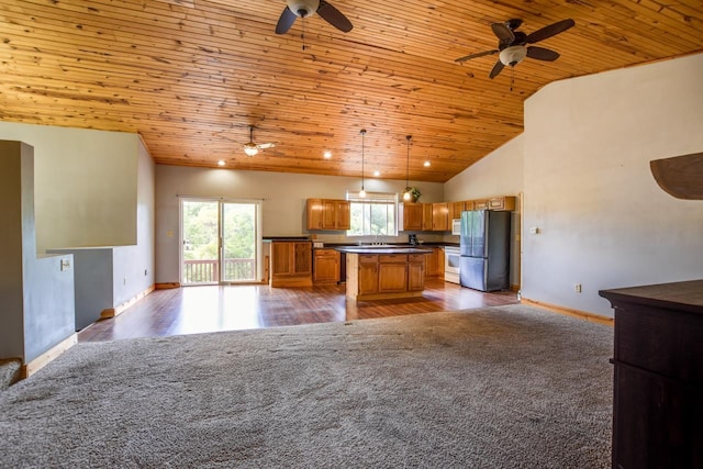 kitchen with white appliances, open floor plan, wooden ceiling, and brown cabinets