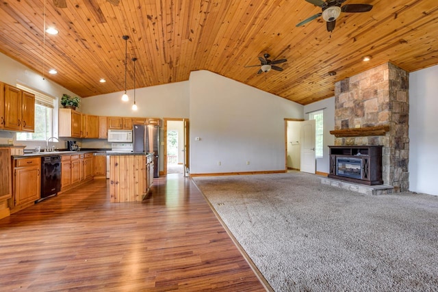 kitchen with dark countertops, open floor plan, wood ceiling, a fireplace, and white appliances