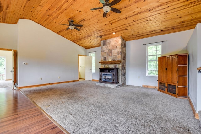 unfurnished living room featuring high vaulted ceiling, a fireplace, wood ceiling, and baseboards