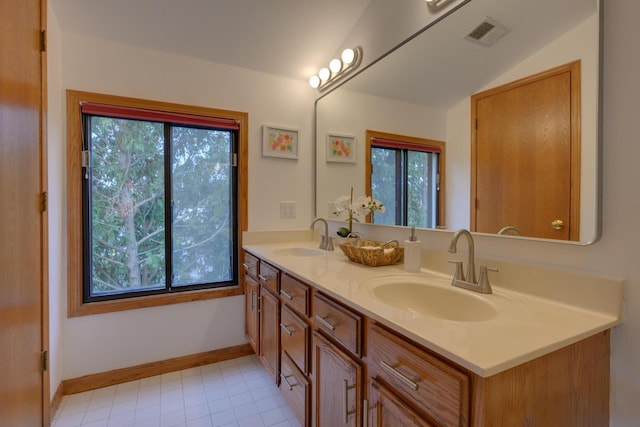 bathroom featuring a wealth of natural light, visible vents, and a sink