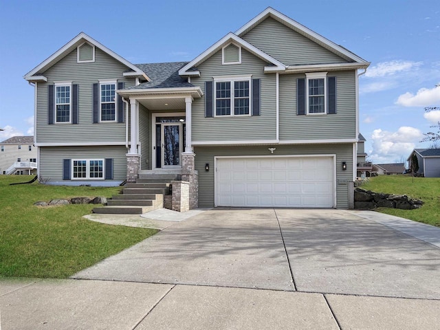 raised ranch with a front lawn, concrete driveway, and an attached garage