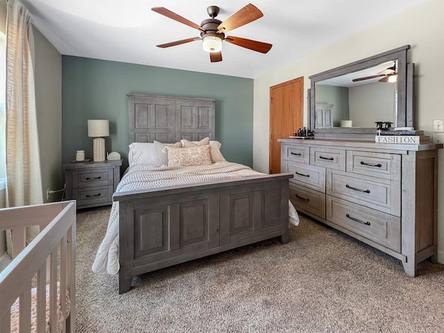 bedroom featuring a ceiling fan and light colored carpet