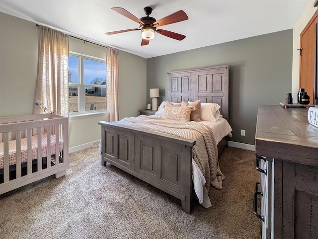 carpeted bedroom featuring baseboards and ceiling fan