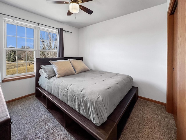 bedroom with ceiling fan, carpet, and baseboards