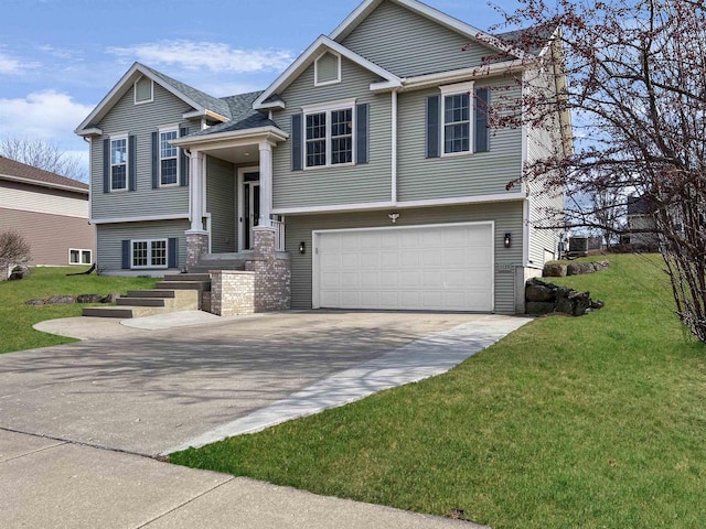 split foyer home with a front yard, a garage, and driveway