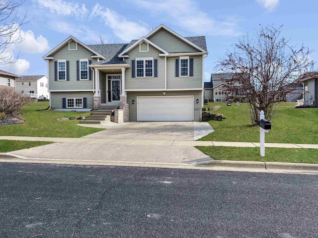 split foyer home featuring driveway, an attached garage, a front lawn, and a shingled roof