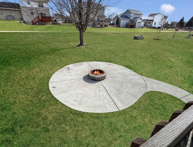 view of yard with a residential view, a patio, and a fire pit