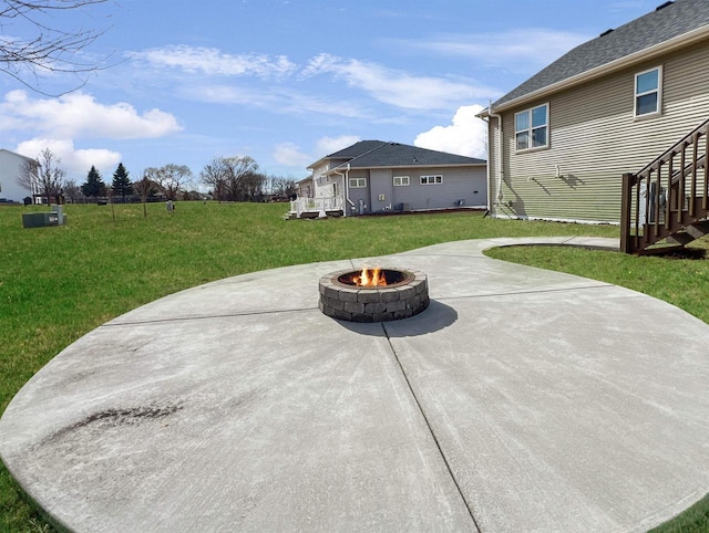 view of patio featuring a fire pit and stairs