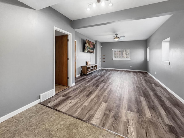 unfurnished room featuring a ceiling fan, wood finished floors, baseboards, and visible vents