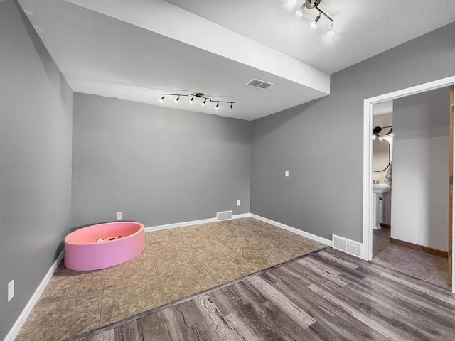 playroom with visible vents, baseboards, and wood finished floors