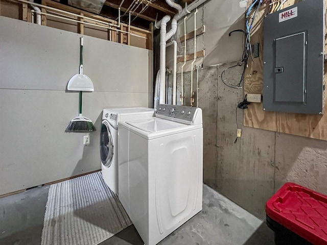 clothes washing area featuring electric panel, laundry area, and independent washer and dryer