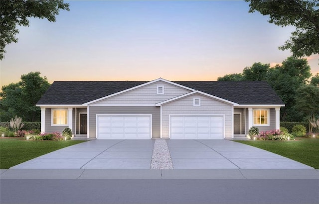 single story home featuring concrete driveway, a lawn, and a garage