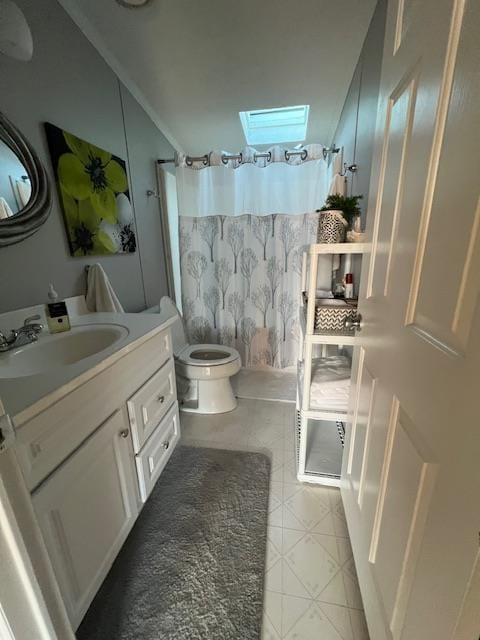 full bath with vanity, a skylight, tile patterned flooring, curtained shower, and toilet