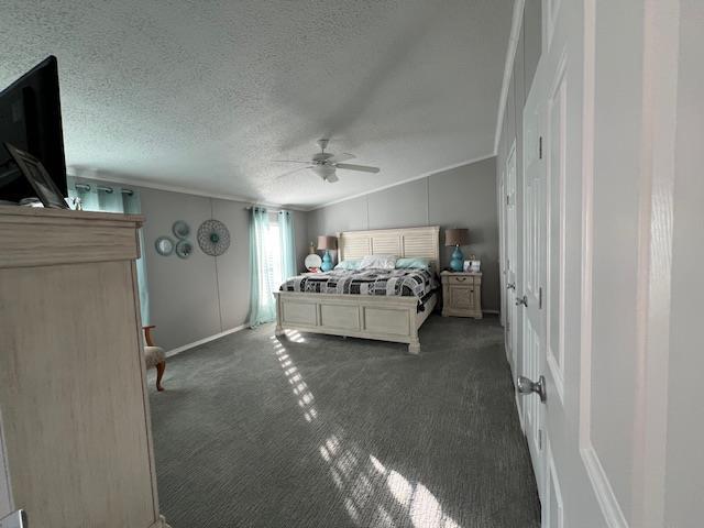 bedroom featuring carpet flooring, a textured ceiling, crown molding, and a ceiling fan