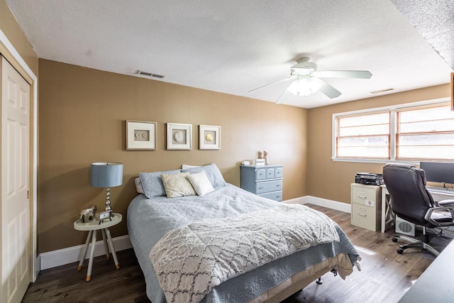 bedroom featuring wood finished floors, visible vents, and baseboards