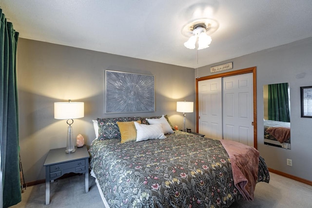 bedroom featuring a closet, carpet flooring, and baseboards