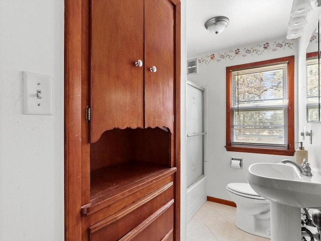 full bath with baseboards, visible vents, tile patterned flooring, toilet, and combined bath / shower with glass door